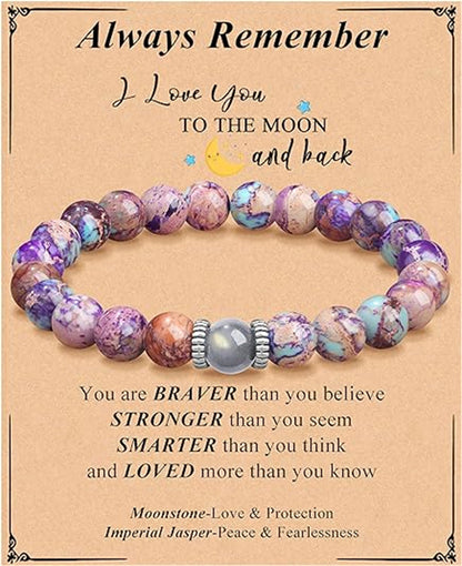 This Natural Purple Emperor Stone Match Moonstone Elastic Beaded Bracelet blends soothing crystal energy with timeless style for everyday wear