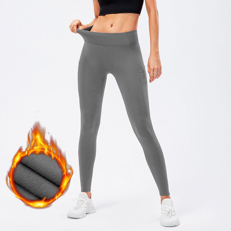 Warm high-waist running pants with moisture-wicking fabric, supportive fit, and pockets.