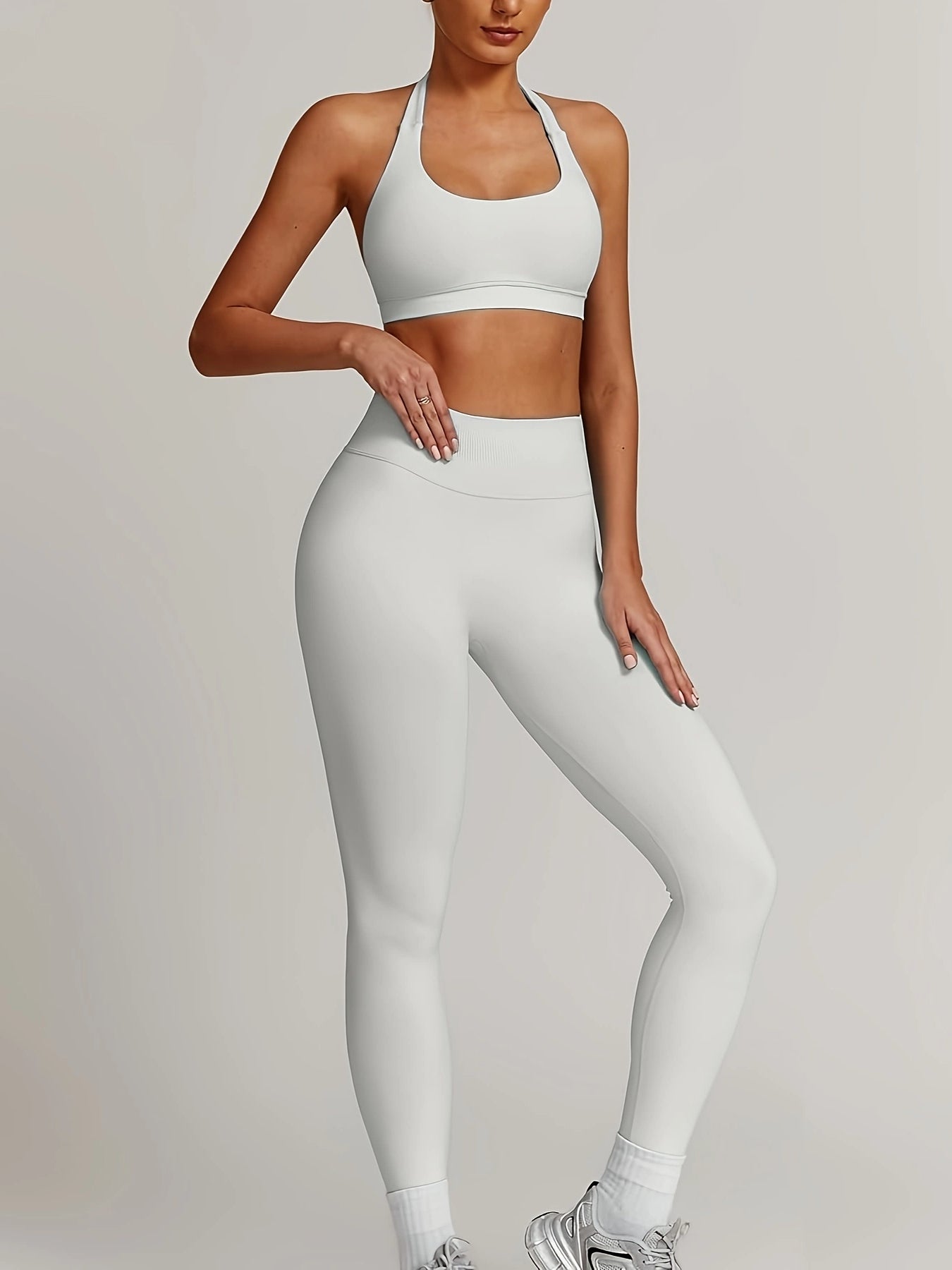 Women’s yoga set with supportive sports bra and high-waist leggings that sculpt and stay put.