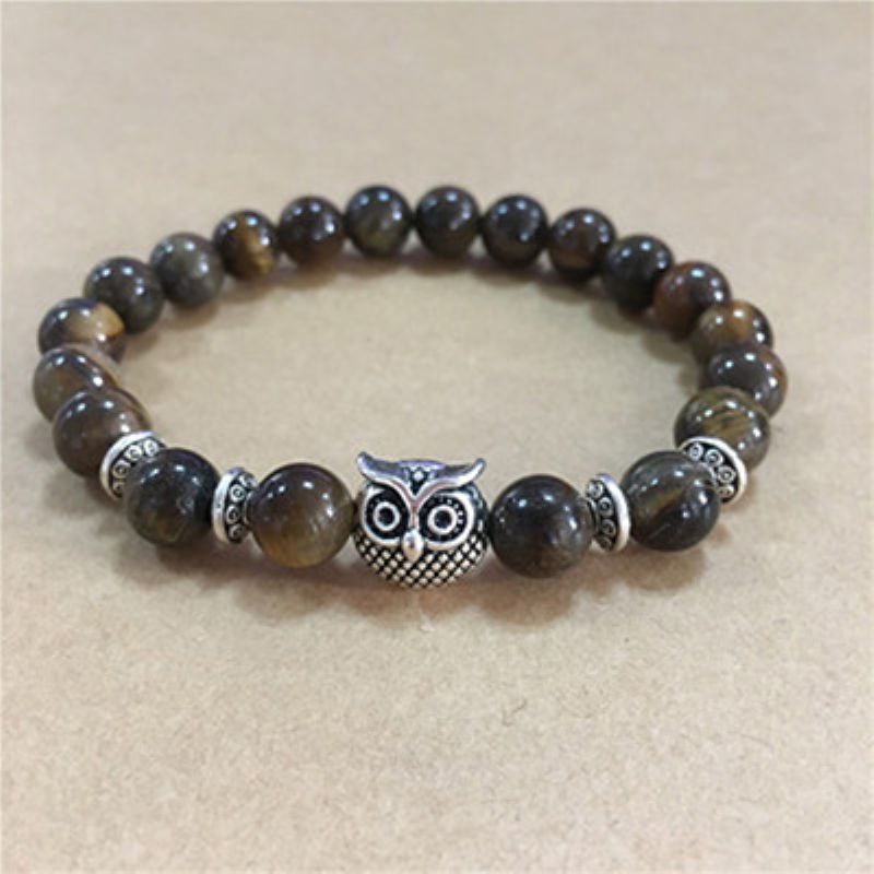 This Owl Tiger’s Eye Volcanic Stone Energy Bracelet combines powerful protection stones with an owl charm representing wisdom and intuition.